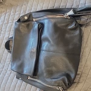 Black soft leather backpack with silver side zippers by Aimee Kesteneerg
